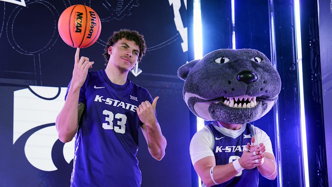 Oct 23, 2024; Kansas City, MO, USA; Kansas State Wildcats guard Coleman Hawkins (33) and mascot Willie the Wildcat pose during the Big 12 Men’s Basketball Media Day at T-Mobile Center. Mandatory Credit: Jay Biggerstaff-Imagn Images