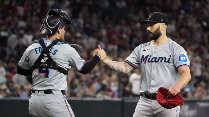 May 26, 2024; Phoenix, Arizona, USA; Miami Marlins catcher Nick Fortes (4) and pitcher Tanner Scott (66) celebrate after defeating the Arizona Diamondbacks at Chase Field. Mandatory Credit: Rick Scuteri-USA TODAY Sports