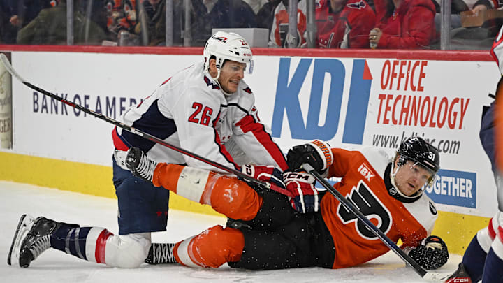 Feb 3, 2026; Philadelphia, Pennsylvania, USA; Washington Capitals center Nic Dowd (26) finishes his check against Philadelphia Flyers right wing Carl Grundstrom (91) during the first period at Xfinity Mobile Arena. Mandatory Credit: Eric Hartline-Imagn Images