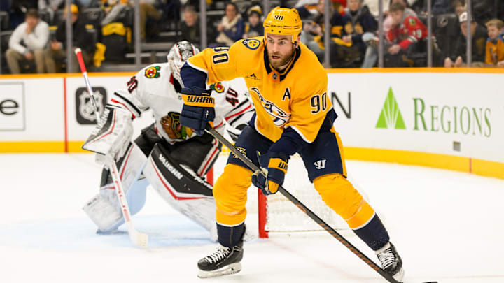 Jan 16, 2025; Nashville, Tennessee, USA;  Nashville Predators center Ryan O'Reilly (90) skates with the puck against the Chicago Blackhawks during the first period at Bridgestone Arena. Mandatory Credit: Steve Roberts-Imagn Images