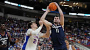 Mar 23, 2025; Raleigh, NC, USA; Connecticut Huskies forward Alex Karaban (11) drives to the basket as Florida Gators forward Alex Condon (21) defends during the first half in the second round of the NCAA Tournament at Lenovo Center. Mandatory Credit: Bob Donnan-Imagn Images