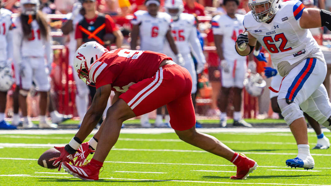 Cornhuskers defensive lineman Williams Nwaneri scoops up the ball before scoring on a 29-yard fumble return