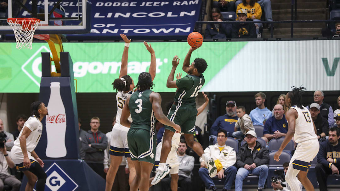 Nov 30, 2025; Morgantown, West Virginia, USA; Mercyhurst Lakers forward Qadir Martin (12) shoots over West Virginia Mountaineers center Harlan Obioha (55) during the second half at Hope Coliseum. Mandatory Credit: Ben Queen-Imagn Images Nov 30, 2025; Morgantown, West Virginia, USA; Mercyhurst Lakers forward Qadir Martin (12) shoots over West Virginia Mountaineers center Harlan Obioha (55) during the second half at Hope Coliseum. Mandatory Credit: Ben Queen-Imagn Images