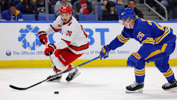 Jan 15, 2025; Buffalo, New York, USA;  Buffalo Sabres defenseman Rasmus Dahlin (26) tries to block a pass by Carolina Hurricanes center Sebastian Aho (20) during the third period at KeyBank Center. Mandatory Credit: Timothy T. Ludwig-Imagn Images