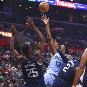Nov 12, 2023; Los Angeles, California, USA; Memphis Grizzlies forward Jaren Jackson Jr. (13) draws an offensive foul against LA Clippers forward Moussa Diabate (25) during the quarter of a game at Crypto.com Arena. 