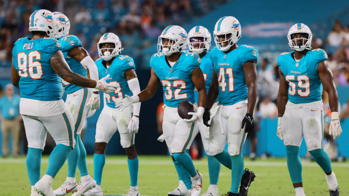 Miami Dolphins safety Patrick McMorris (32) celebrates with teammates after recovering a fumble against the Washington Commanders during the fourth quarter of a preseason game at Hard Rock Stadium.