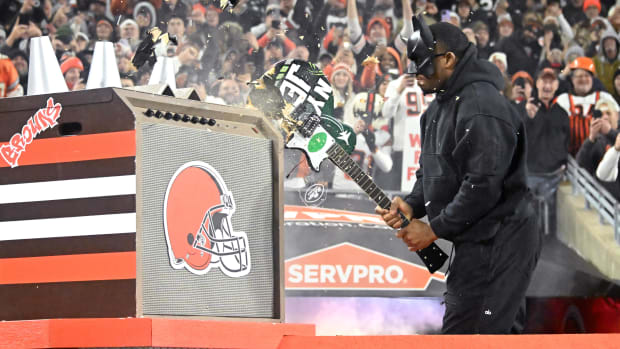 Cleveland Browns running back Nick Chubb (right) breaks guitar painted in New York Jets colors and logos before the game