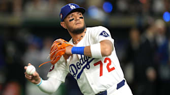 Mar 19, 2025; Bunkyo, Tokyo, JPN; Los Angeles Dodgers shortstop Miguel Rojas (72) throws a ball into the stands before the game against the Chicago Cubs during the Tokyo Series at Tokyo Dome. Mandatory Credit: Darren Yamashita-Imagn Images