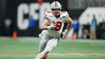 Jan 20, 2025; Atlanta, GA, USA; Ohio State Buckeyes quarterback Will Howard (18) runs the ball against the Notre Dame Fighting Irish in the second half in the CFP National Championship college football game at Mercedes-Benz Stadium. Mandatory Credit: Kirby Lee-Imagn Images