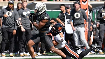 Sep 20, 2025; Eugene, Oregon, USA; Oregon State Beavers linebacker Aiden Sullivan (2) forces a fumble by Oregon Ducks tight end Kenyon Sadiq (18) during the third quarter of the game at Autzen Stadium. Mandatory Credit: Troy Wayrynen-Imagn Images