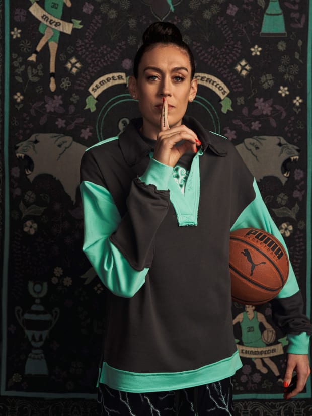 Breanna Stewart models black and green PUMA apparel.