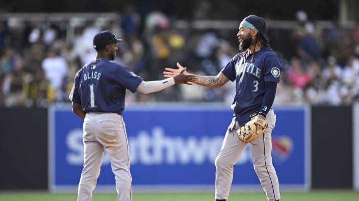 Seattle Mariners shortstop J.P. Crawford (3) and second baseman Ryan Bliss (1) celebrate on the field after defeating the San Diego Padres at Petco Park in 2024.