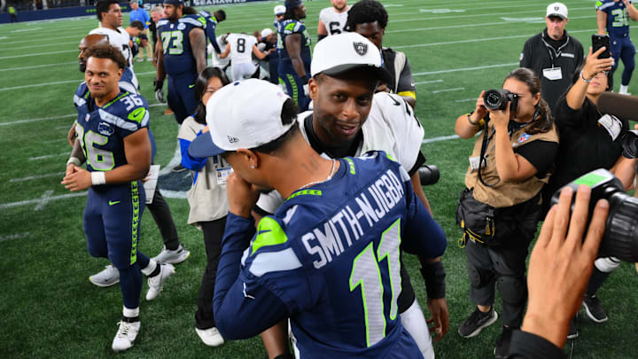 Las Vegas Raiders quarterback Geno Smith and Seattle Seahawks wide receiver Jaxon Smith-Njigba hug after the game Las Vegas Raiders quarterback Geno Smith and Seattle Seahawks wide receiver Jaxon Smith-Njigba hug after the game