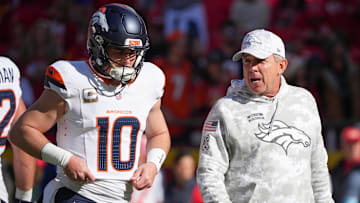 Nov 10, 2024; Kansas City, Missouri, USA; Denver Broncos quarterback Bo Nix (10) talks with head coach Sean Peyton   against the Kansas City Chiefs prior to a game at GEHA Field at Arrowhead Stadium. 