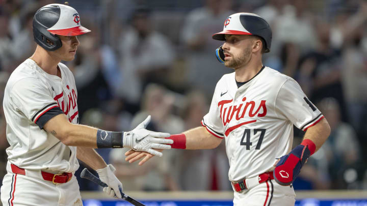 May 8, 2024; Minneapolis, Minnesota, USA; Minnesota Twins second baseman Edouard Julien (47) celebrates with right fielder Max Kepler (26) after scoring a run against the Seattle Mariners in the eighth inning at Target Field.