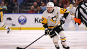Jan 17, 2025; Buffalo, New York, USA;  Pittsburgh Penguins right wing Bryan Rust (17) skates up ice with the puck during the first period against the Buffalo Sabres at KeyBank Center. Mandatory Credit: Timothy T. Ludwig-Imagn Images
