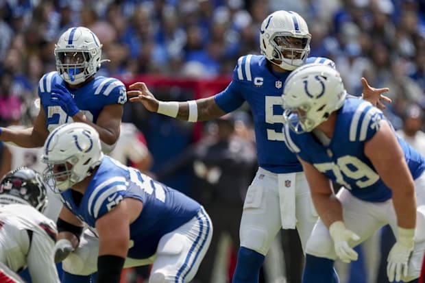 Indianapolis Colts quarterback Anthony Richardson talks at the line of scrimmage in a blue jersey.