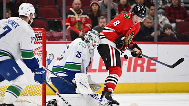 Feb 13, 2024; Chicago, Illinois, USA; Chicago Blackhawks forward Ryan Donato (8) screens Vancouver Canucks goaltender Thatcher Demko (35) on a shot in the third period at United Center. Mandatory Credit: Jamie Sabau-Imagn Images