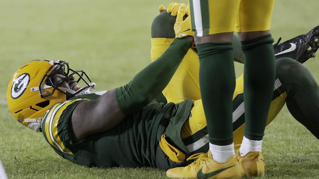 Dec 27, 2025; Green Bay, Wisconsin, USA; Green Bay Packers cornerback Nate Hobbs (21) is injured during the second quarter against the Baltimore Ravens at Lambeau Field.