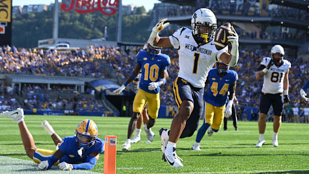 West Virginia Mountaineers running back Jahiem White (1) scores a touchdown  against Pittsburgh Panthers