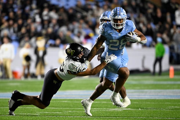 North Carolina Tar Heels running back Omarion Hampton runs as Wake Forest DB Nick Andersen defends