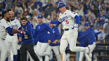 Oct 27, 2025; Los Angeles, California, USA; Los Angeles Dodgers first baseman Freddie Freeman (5) celebrates with teammates after hitting a walk off home run against the Toronto Blue Jays in the eighteenth inning during game three of the 2025 MLB World Series at Dodger Stadium. Mandatory Credit: Jayne Kamin-Oncea-Imagn Images