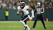 Nov 10, 2025; Green Bay, Wisconsin, USA; Philadelphia Eagles quarterback Jalen Hurts (1) scrambles against the Green Bay Packers in the first half at Lambeau Field. Mandatory Credit: Jeff Hanisch-Imagn Images