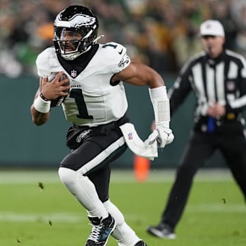 Nov 10, 2025; Green Bay, Wisconsin, USA; Philadelphia Eagles quarterback Jalen Hurts (1) scrambles against the Green Bay Packers in the first half at Lambeau Field. Mandatory Credit: Jeff Hanisch-Imagn Images