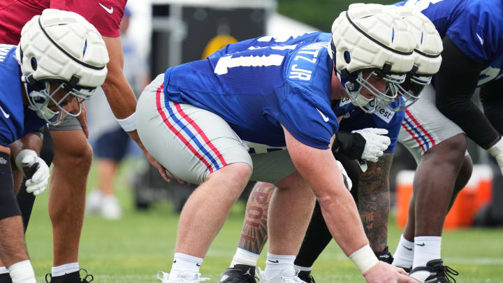 Jul 25, 2024; East Rutherford, NY, USA; New York Giants center John Michael Schmitz Jr. (61) waits to snap the ball during Quest Diagnostics Training Center training camp.  