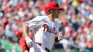 Feb 28, 2025; Clearwater, Florida, USA;  Philadelphia Phillies catcher J.T. Realmuto (10) hits a RBI single against the Boston Red Sox during the third inning at BayCare Ballpark.
