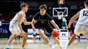 Grand View Christian's Brayden Hoben (21) drives down the court against Western Christian's Karsten Moret (2) on Thursday, March 13, 2025, at Wells Fargo Arena in Des Moines.