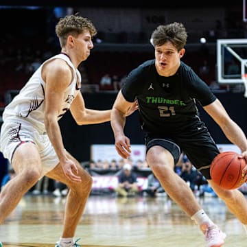 Grand View Christian's Brayden Hoben (21) drives down the court against Western Christian's Karsten Moret (2) on Thursday, March 13, 2025, at Wells Fargo Arena in Des Moines.