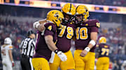 Arizona State Sun Devils running back Cam Skattebo (4) and offensive lineman Leif Fautanu (79) and quarterback Sam Leavitt (10) celebrate after Skattebo scored a rushing touchdown against Iowa State.