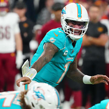 Miami Dolphins quarterback Tua Tagovailoa (1) calls a play at the line of scrimmage against the Washington Commanders in the second quarter during the 2025 NFL Madrid Game at Santiago Bernabeu Stadium. 