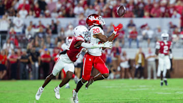 Sep 7, 2024; Norman, Oklahoma, USA;  Houston Cougars defensive back Jeremiah Wilson (20) makes an interception in front of Oklahoma Sooners wide receiver Zion Ragins (81) but it is called back for a penalty during the second half at Gaylord Family-Oklahoma Memorial Stadium. Mandatory Credit: Kevin Jairaj-Imagn Images
