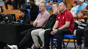 Indiana University men's head basketball coach Darian DeVries (left) watches the game Wednesday, April 2, 2025, during the first game of the Chipotle Nationals at Hamilton Southeastern High School in Fishers. Drew Adams is pictured in the Indiana shirt next to fellow Indiana assistant coach Nick Norton.