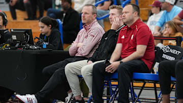 Indiana University men's head basketball coach Darian DeVries (left) watches the game Wednesday, April 2, 2025, during the first game of the Chipotle Nationals at Hamilton Southeastern High School in Fishers.