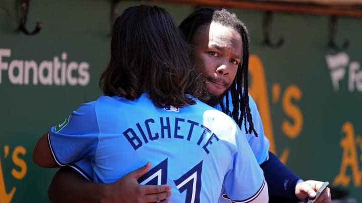 Jun 9, 2024; Oakland, California, USA; Toronto Blue Jays first baseman Vladimir Guerrero Jr. (right) and shortstop Bo Bichette (11) greet each other before the game against the Oakland Athletics at Oakland-Alameda County Coliseum