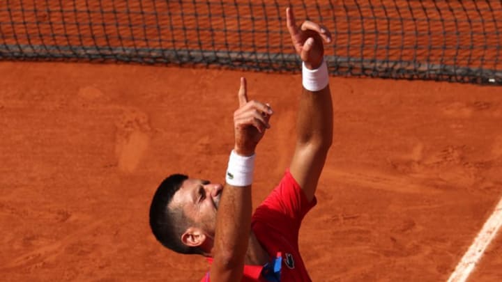 Novak Djokovic emotionally reacts after defeating Carlos Alcaraz to win the gold medal in men's singles on Court Philippe-Chatrier at Roland Garros in the 2024 Paris Olympics on Sunday, August 4. 