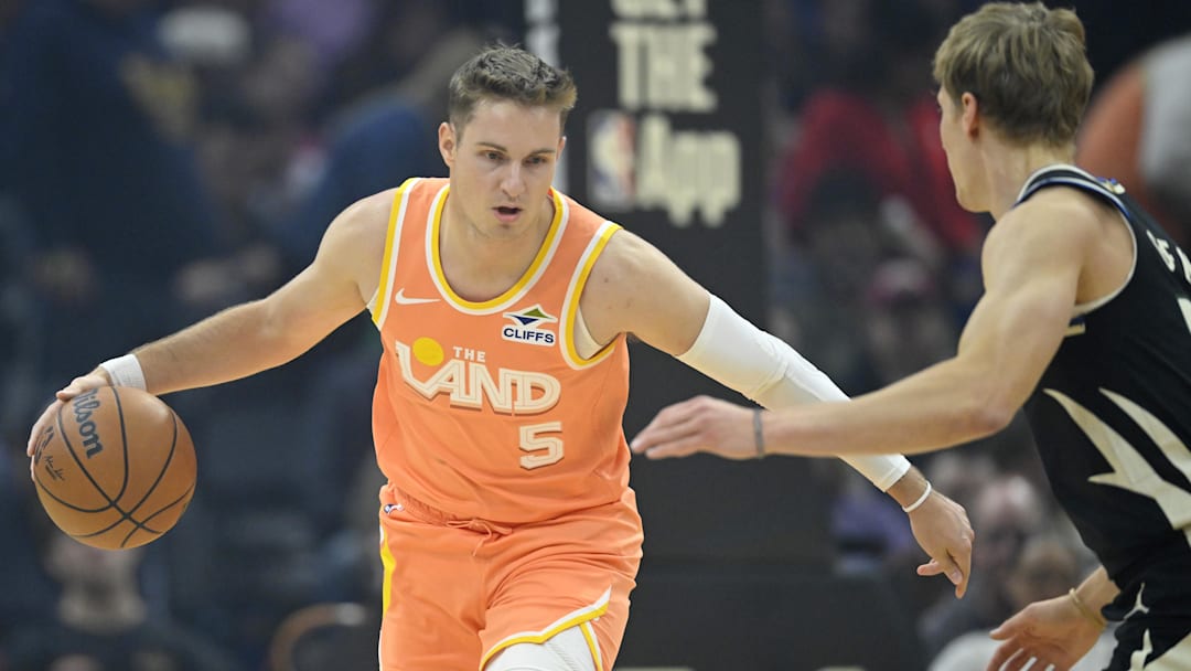 Nov 17, 2025; Cleveland, Ohio, USA; Cleveland Cavaliers guard Sam Merrill (5) brings the ball up court beside Milwaukee Bucks guard AJ Green (20) in the first quarter at Rocket Arena. Mandatory Credit: David Richard-Imagn Images