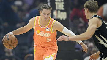 Nov 17, 2025; Cleveland, Ohio, USA; Cleveland Cavaliers guard Sam Merrill (5) brings the ball up court beside Milwaukee Bucks guard AJ Green (20) in the first quarter at Rocket Arena. Mandatory Credit: David Richard-Imagn Images