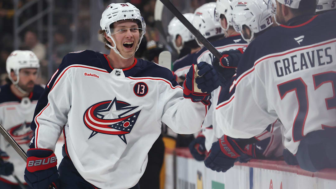 Mar 21, 2025; Pittsburgh, Pennsylvania, USA;  Columbus Blue Jackets center Kent Johnson (91) celebrates with the  Blue Jackets bench after scoring a goal against the Pittsburgh Penguins during the third period at PPG Paints Arena. Mandatory Credit: Charles LeClaire-Imagn Images