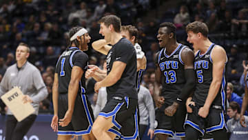 Feb 11, 2025; Morgantown, West Virginia, USA; Brigham Young Cougars guard Trey Stewart (1) celebrates with teammates after a timeout is called during the first half against the West Virginia Mountaineers at WVU Coliseum. Mandatory Credit: Ben Queen-Imagn Images