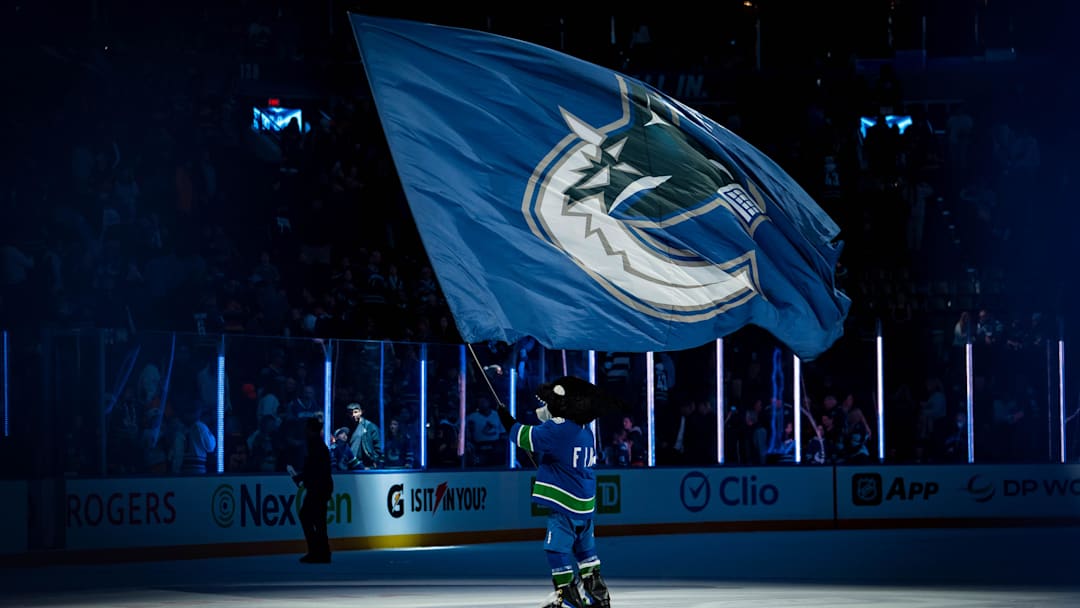 Sep 26, 2025; Vancouver, British Columbia, CAN; Vancouver Canucks mascot Fin celebrates the Canucks victory against the Seattle Kraken at Rogers Arena. Mandatory Credit: Bob Frid-Imagn Images