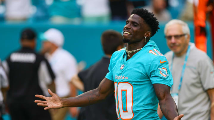 Aug 9, 2024; Miami Gardens, Florida, USA; Miami Dolphins wide receiver Tyreek Hill (10) reacts as he walks on the field before the game against the Atlanta Falcons at Hard Rock Stadium. 