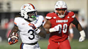 Oct 4, 2025; Louisville, Kentucky, USA; Virginia Cavaliers running back J'Mari Taylor (3) runs the ball against Louisville Cardinals defensive lineman Rene Konga (90) during the second quarter at L&N Federal Credit Union Stadium. Mandatory Credit: Jamie Rhodes-Imagn Images