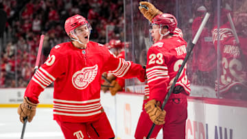 Albert Johansson (left) and Lucas Raymond celebrate as the Detroit Red Wings score against the Toronto Maple Leafs.