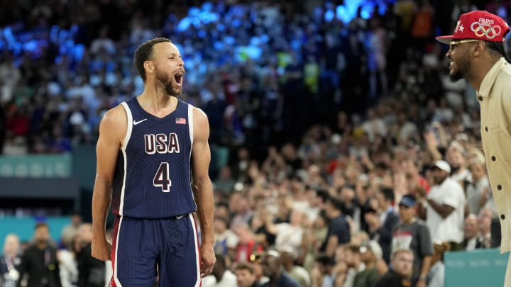 Aug 10, 2024; Paris, France; United States shooting guard Stephen Curry (4) celebrates with Carmelo Anthony in the second half against France in the men's basketball gold medal game during the Paris 2024 Olympic Summer Games at Accor Arena. Mandatory Credit: Kyle Terada-USA TODAY Sports