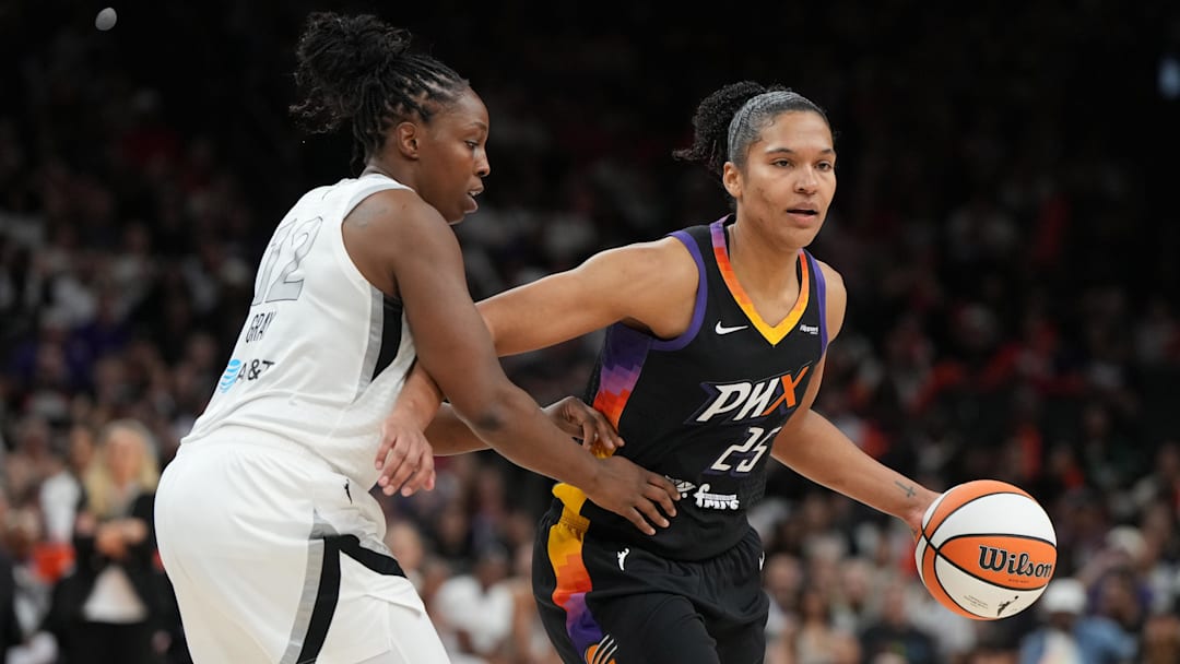 Jun 29, 2025; Phoenix, Arizona, USA; Phoenix Mercury forward Alyssa Thomas (25) shields the ball from Las Vegas Aces guard Chelsea Gray (12) in the second half at Footprint Center. Mandatory Credit: Rick Scuteri-Imagn Images