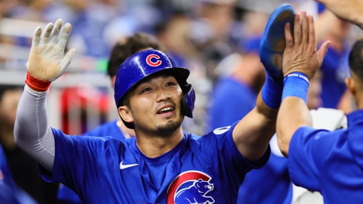 Aug 23, 2024; Miami, Florida, USA; Chicago Cubs designated hitter Seiya Suzuki (27) celebrates with teammates after scoring against the Miami Marlins during the eighth inning at loanDepot Park. Mandatory Credit: Sam Navarro-USA TODAY Sports